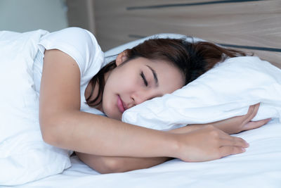 Young woman sleeping on bed