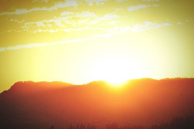 Scenic view of silhouette mountains against sky during sunset