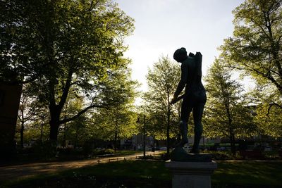 Low angle view of statue in park against sky