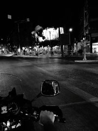 Cars parked on road at night