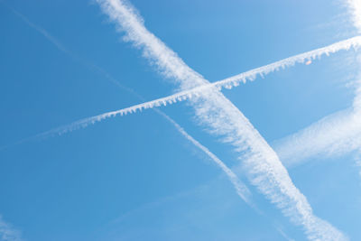 Switzerland, may 11, 2022 contrails formation on a sunny day in spring time
