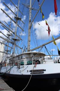 Low angle view of sailboat moored in sea against sky