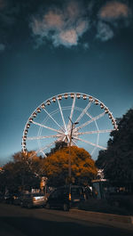 Low angle view of ferris wheel against sky