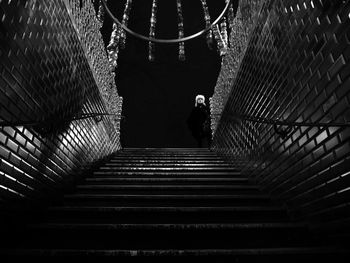 Low angle view of people walking on staircase