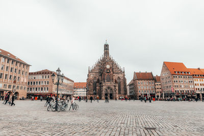 Group of people in front of buildings in city