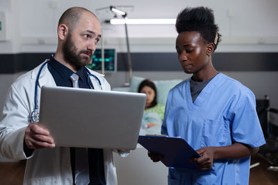 Doctor and nurse having discussion at hospital