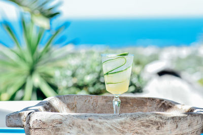 Close-up of drink on table against sea