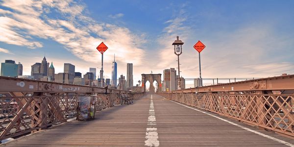 Empty walkway on brooklyn bridge against sky