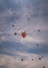 Low angle view of hot air balloons flying in sky