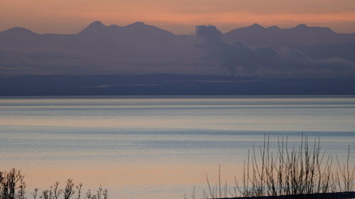 Scenic view of lake against orange sky