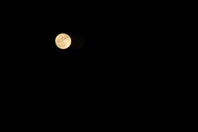 Low angle view of moon against clear sky at night