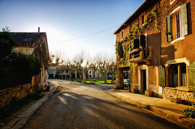 Empty road amidst buildings in town