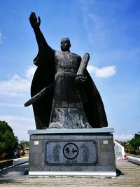 Statue against sky in city