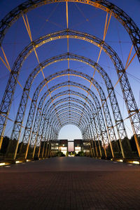 Low angle view of illuminated bridge against sky in city