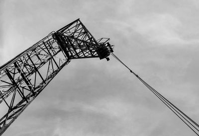 Low angle view of crane against sky