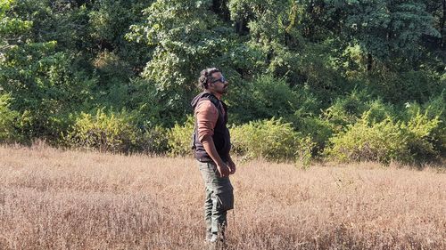 Side view of man standing on field