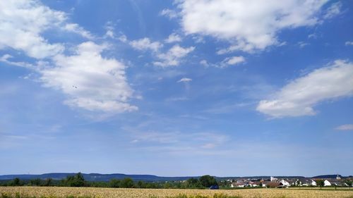 Low angle view of land against blue sky