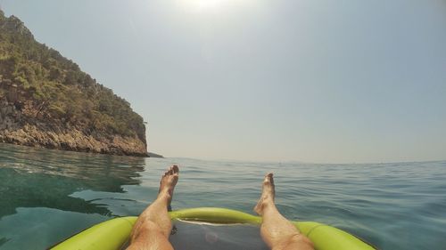 Low section of man relaxing in water