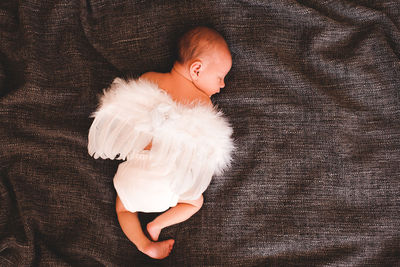 High angle view of baby girl sleeping on bed at home