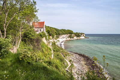 Scenic view of sea and buildings against sky