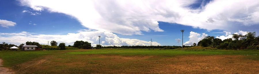 Panoramic view of golf course against sky