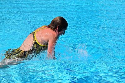 Mature woman swimming in pool