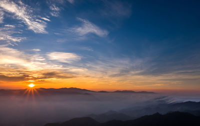 Scenic view of silhouette mountains against sky during sunset