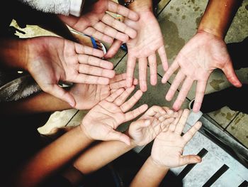 High angle view of hands touching baby