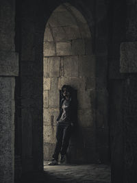 Full length of woman against wall in building