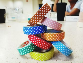Close-up of stacked colorful adhesive tapes on table
