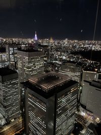 High angle view of illuminated modern buildings in city at night