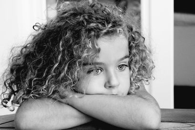 Close-up of thoughtful girl leaning on table