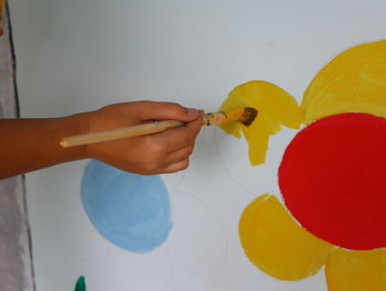 Low section of person holding balloons