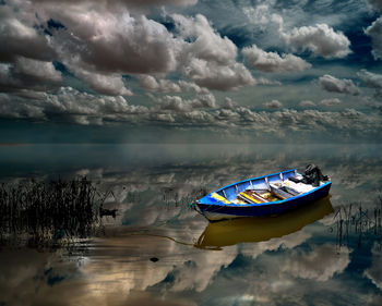 Boat moored in sea against sky