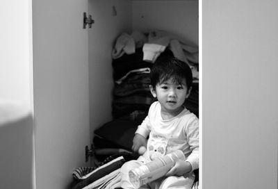 Portrait of cute boy sitting at home