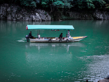 People in boat on sea