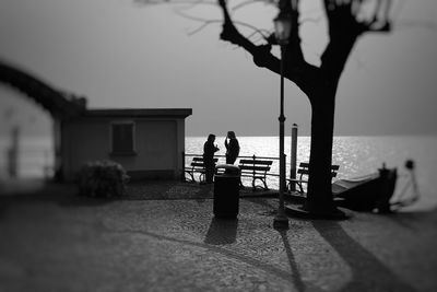 Man and woman in sea against sky