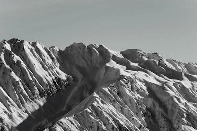 Scenic view of snow mountains against clear sky