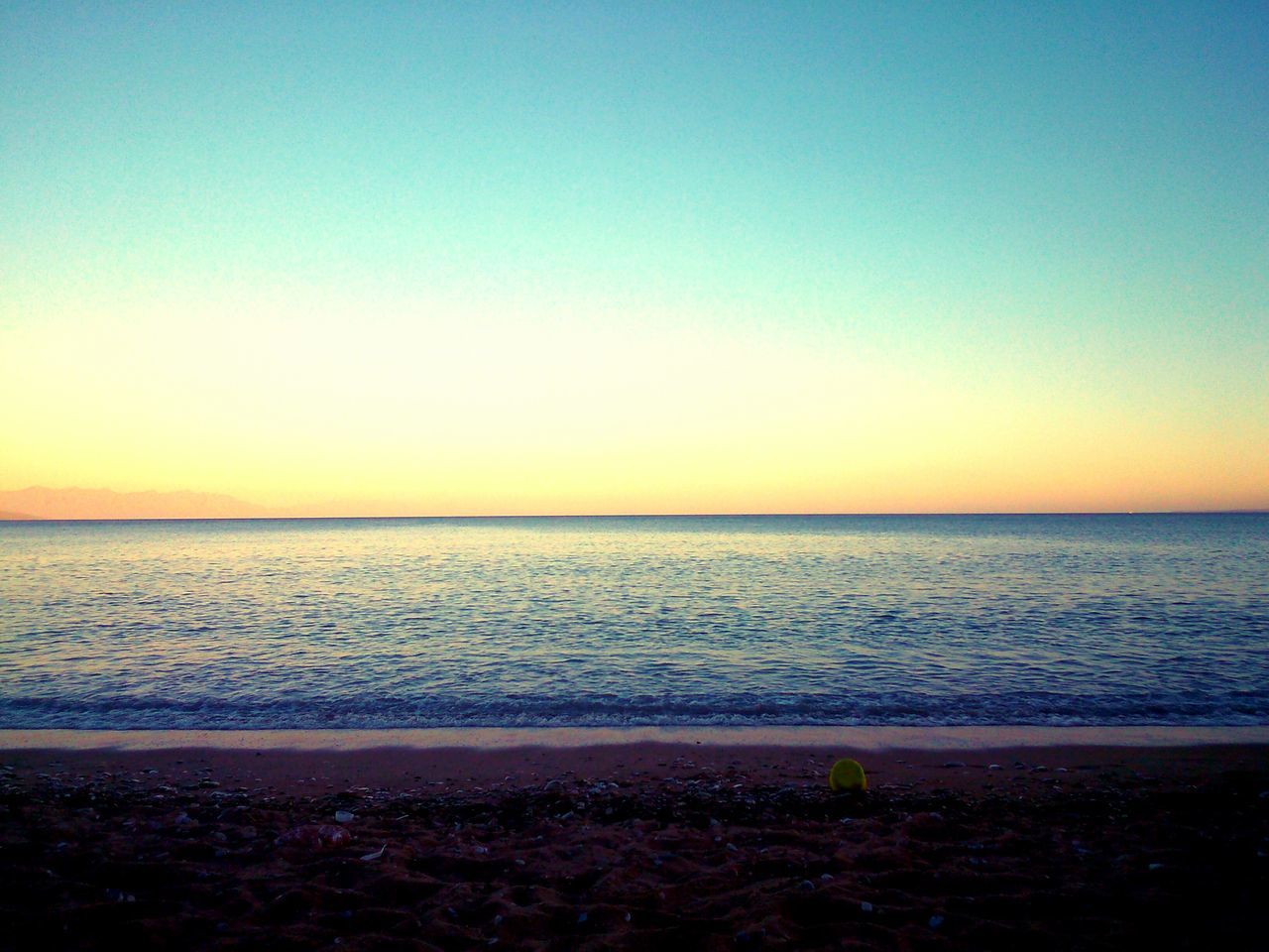 sea, horizon over water, water, sunset, scenics, tranquil scene, beach, clear sky, copy space, tranquility, beauty in nature, shore, nature, idyllic, orange color, coastline, sky, blue, calm, dusk