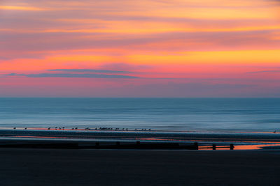 Scenic view of sea against sky during sunrise