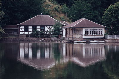 Reflection of trees and buildings in lake