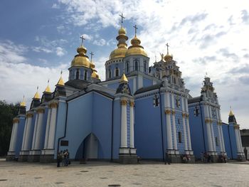 Low angle view of church against cloudy sky