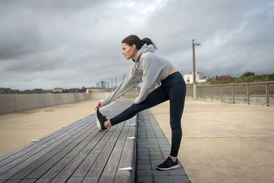 Side view of man standing on boardwalk