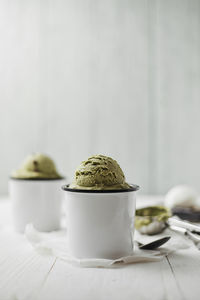 Close-up of ice cream in mugs on table