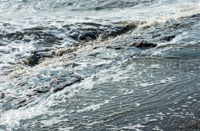 High angle view of waves splashing on shore