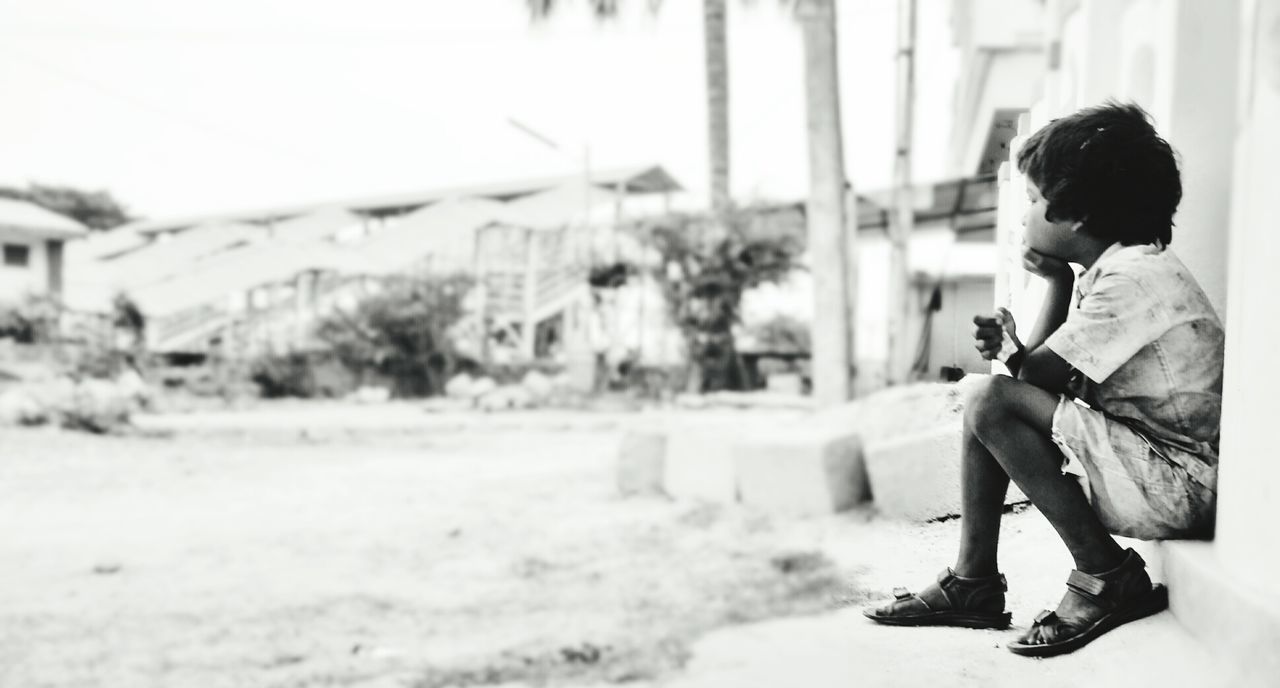 BOY STANDING IN PARK