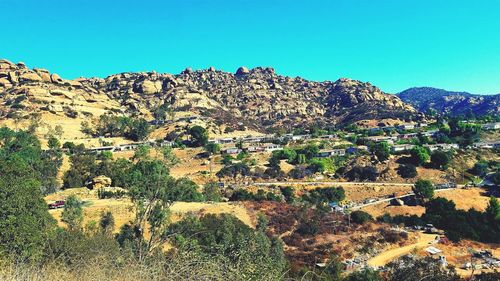 Scenic view of mountains against clear blue sky