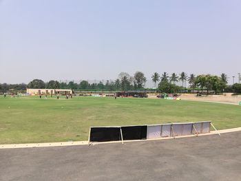 People on field against clear sky