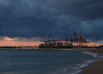 Ransportation and logistic background - sea containers are off loaded from vessels by huge cranes