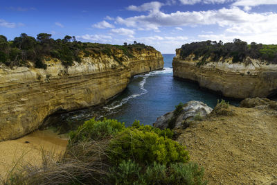 Scenic view of rocks in sea against sky